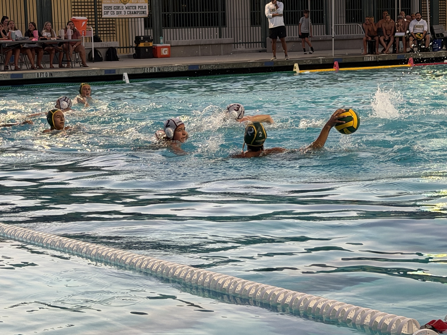 Whitney defenders track a Kingsburg player holding the ball.